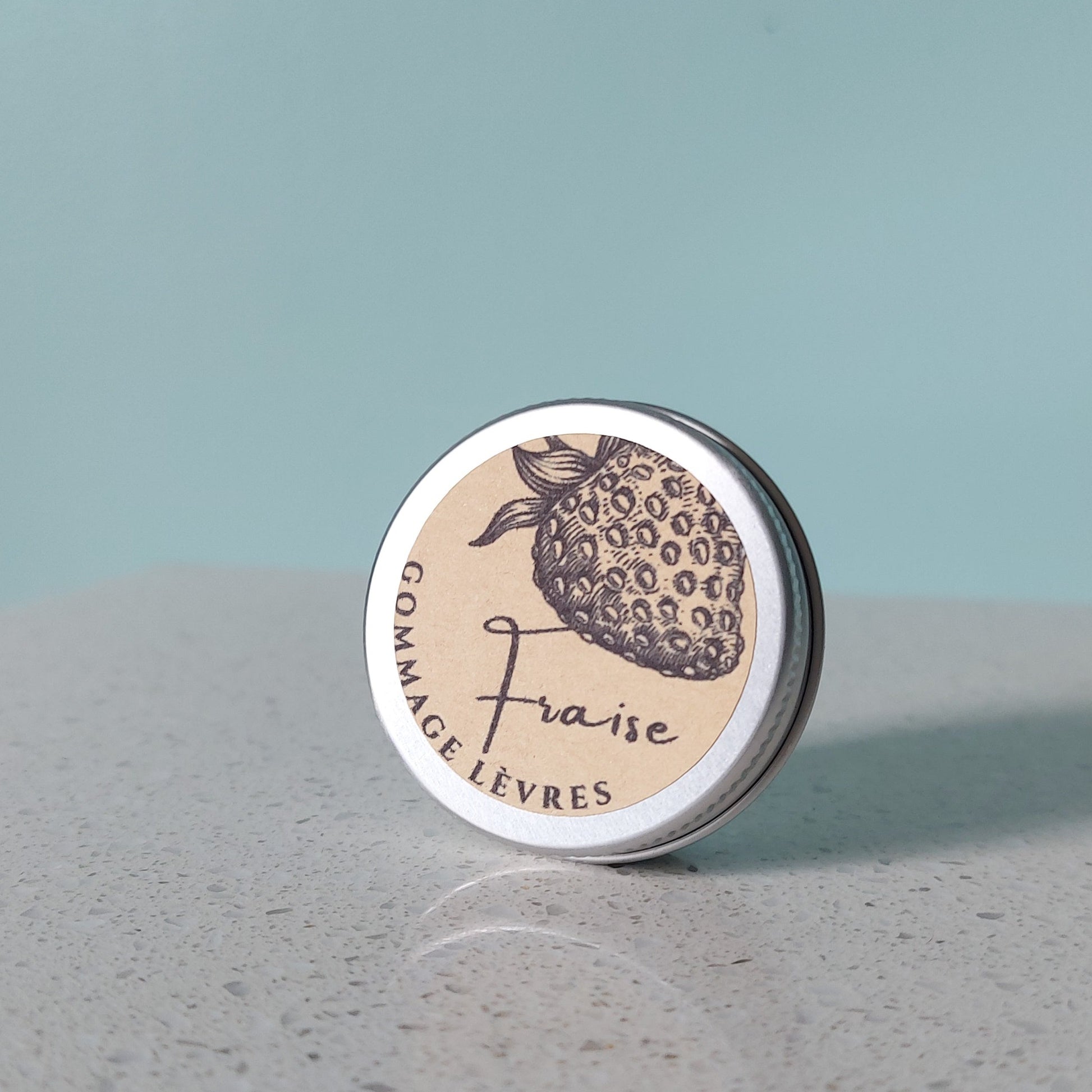 Organic strawberry lip scrub in aluminium tin with kraft paper label