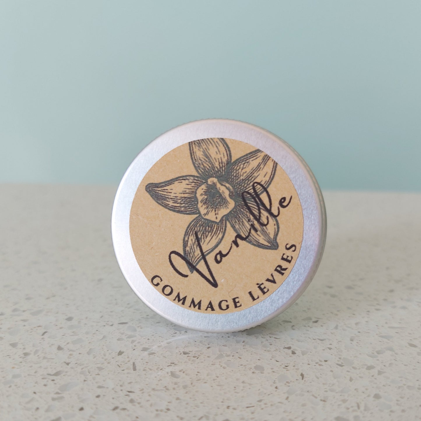 Vanilla lip scrub in metal tin with kraft paper sticker